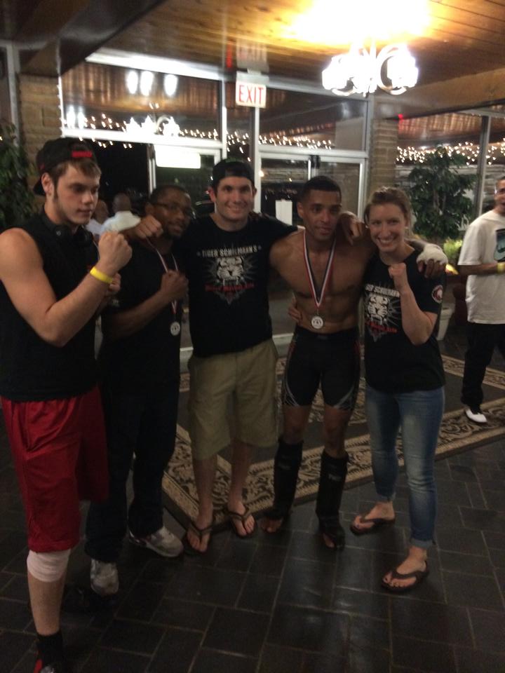 Tiger Schulmann's fighter with a medal and his fans