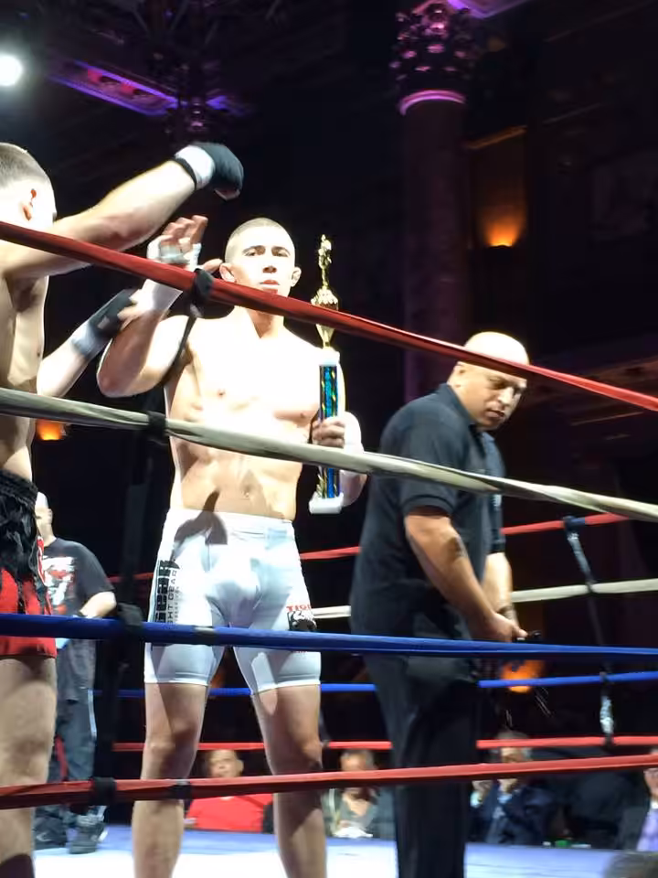 Tiger Schulmann's Martial Arts fighter Holding Trophy