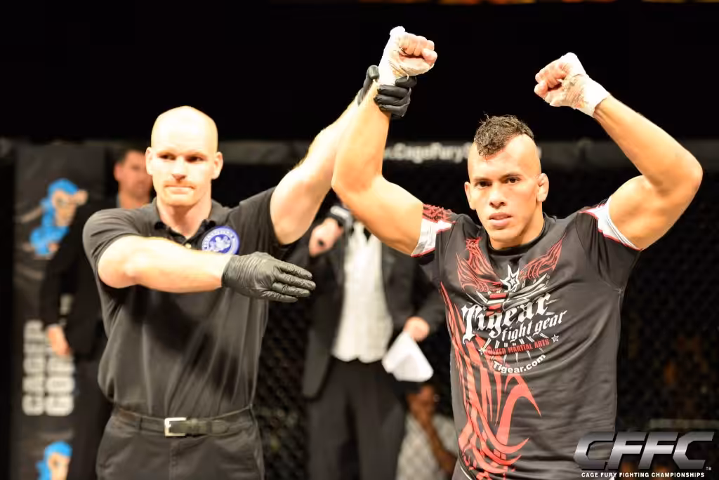 Referee raises hand of the winner Tiger Schulmann's fighter in ring