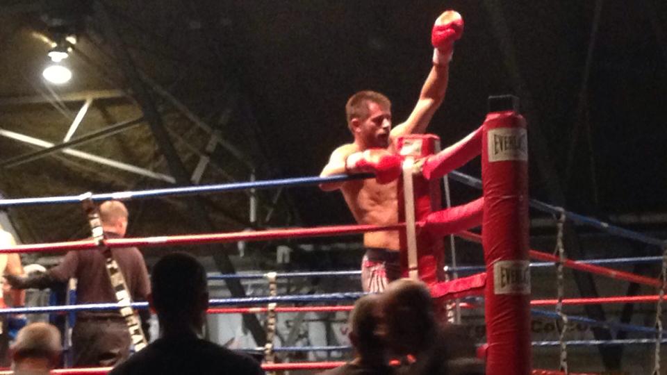 Tiger Schulmann's Martial Arts fighter Raising Hand victoriously in ring
