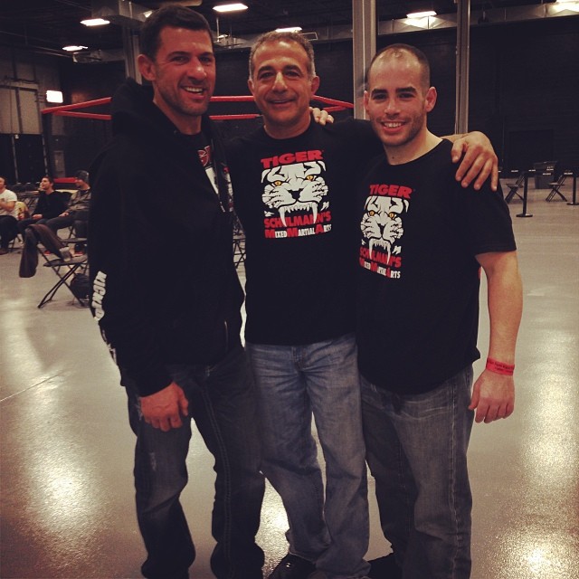 Three MMA fighters in Tiger Schulmann's apparel in gym