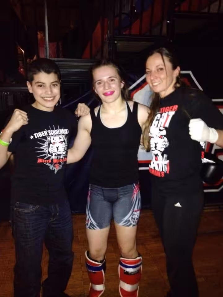 Three girls fighters standing at Tiger Schulmann's gym