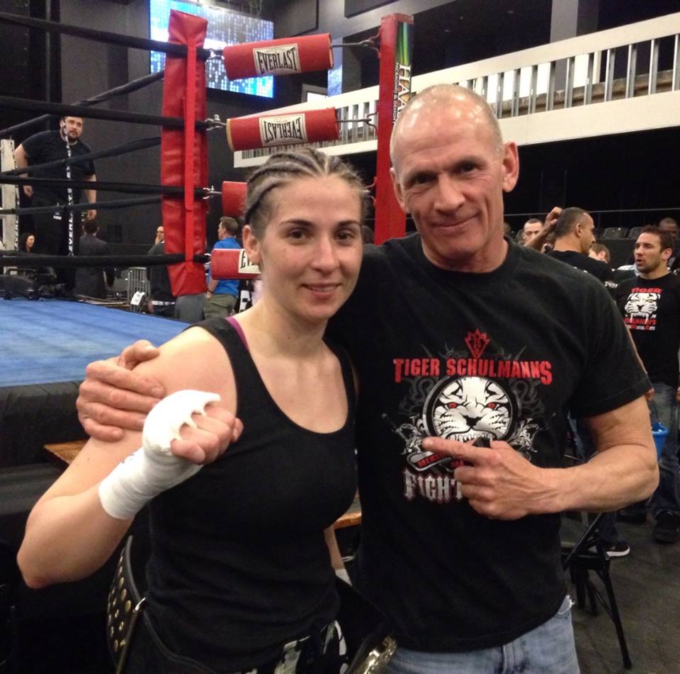 Coach in Tiger Schulmann's shirt Pointing at Woman fighter