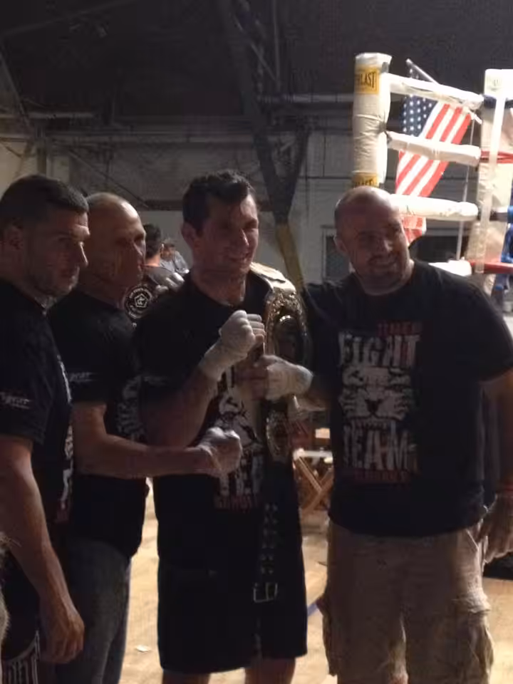 Four members of Tiger Schulmann's Martial Arts near the ring
