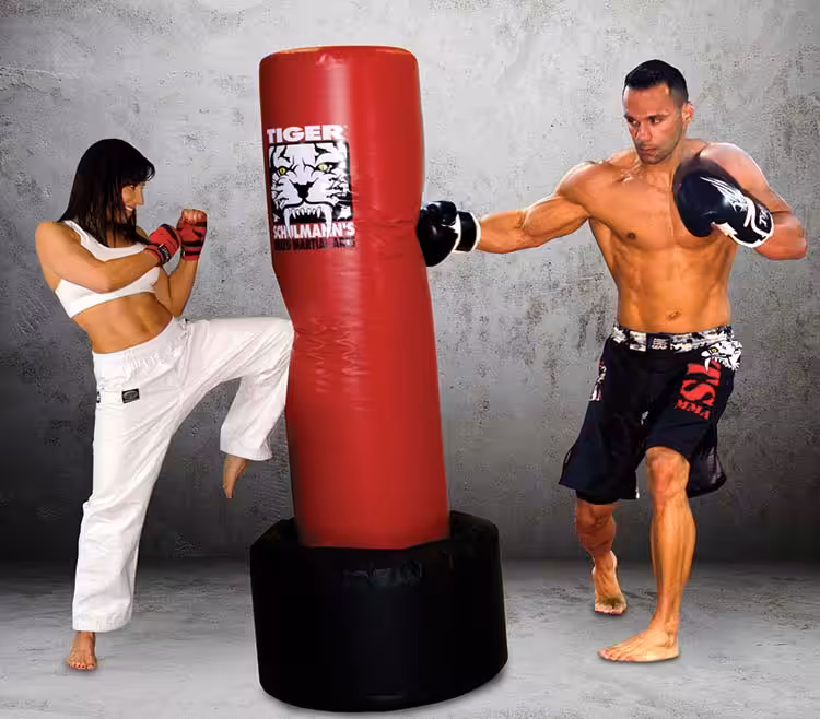 Woman Kicking and Man Punching a red Tiger Schulmann's practice bag