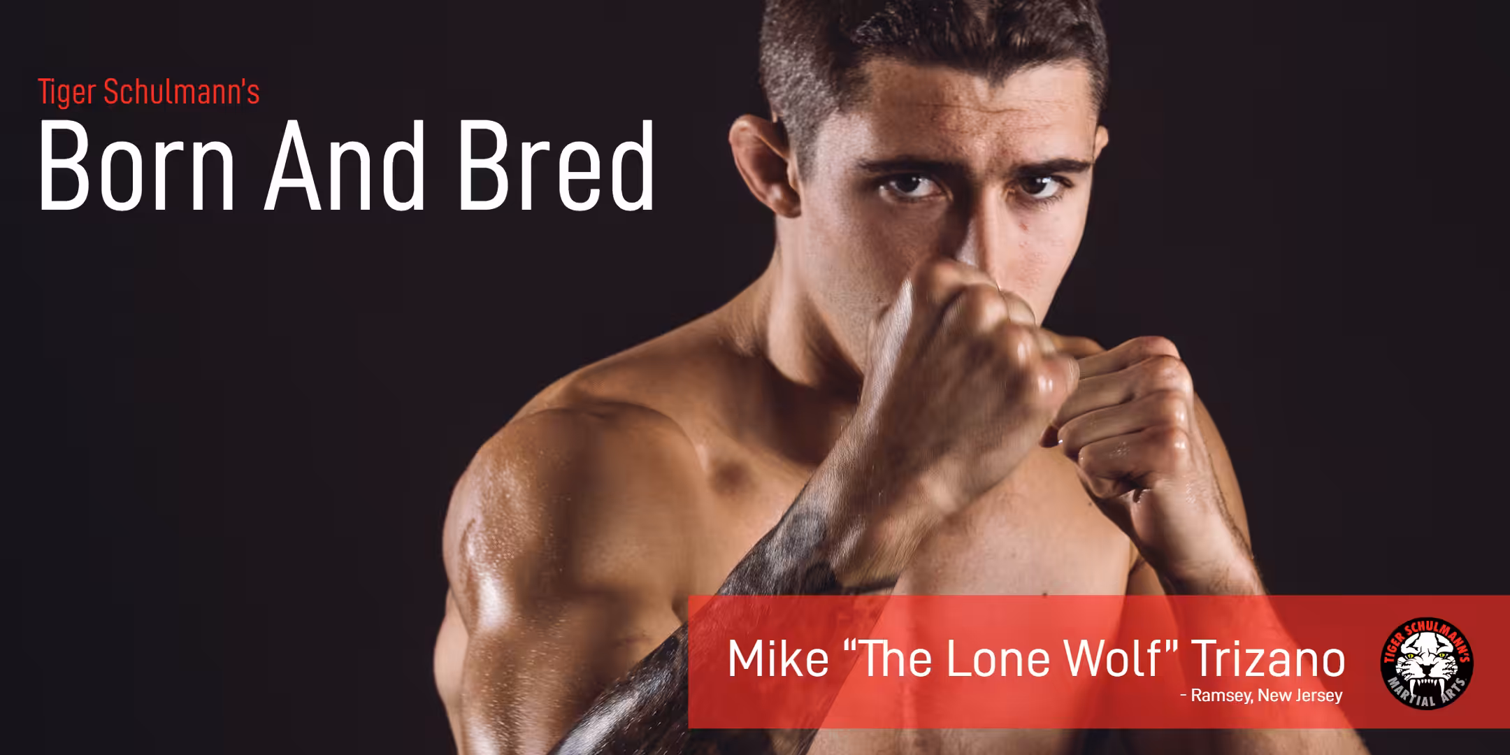 Mike the lone wolf Trizano with his fists up in the air - Tiger Schulmann's born and bred 