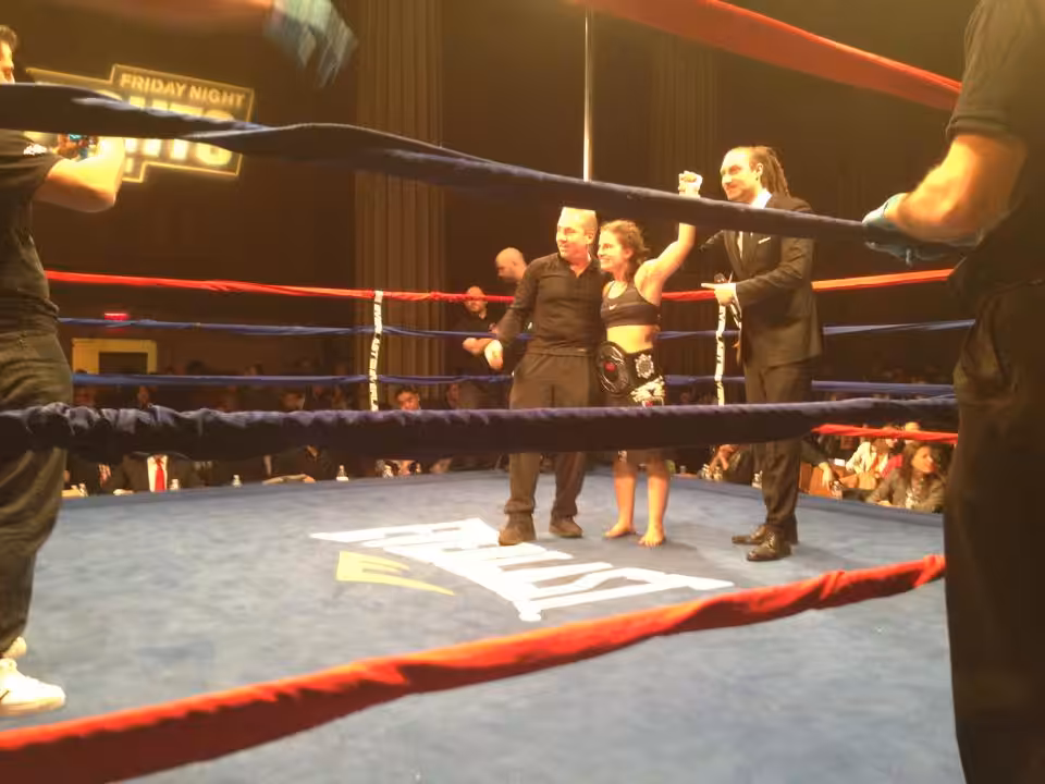Woman's Hand Raised in a ring after a fight