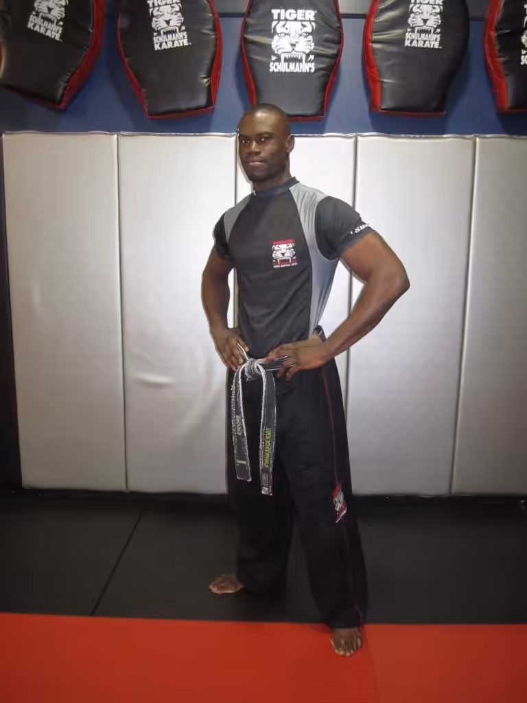 MMA fighter standing with hands on his hips at Tiger Schulmann's