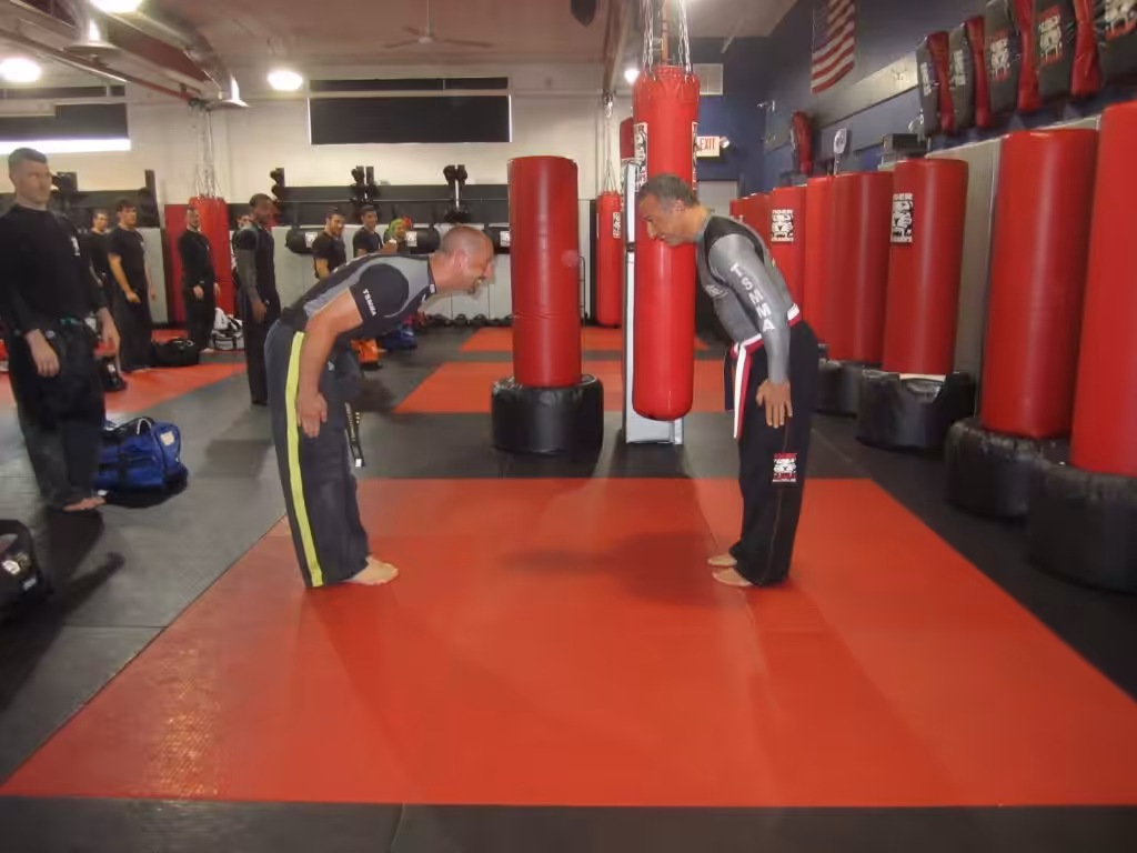 Men Bowing during the black belt ceremony at Tiger Schulmann's