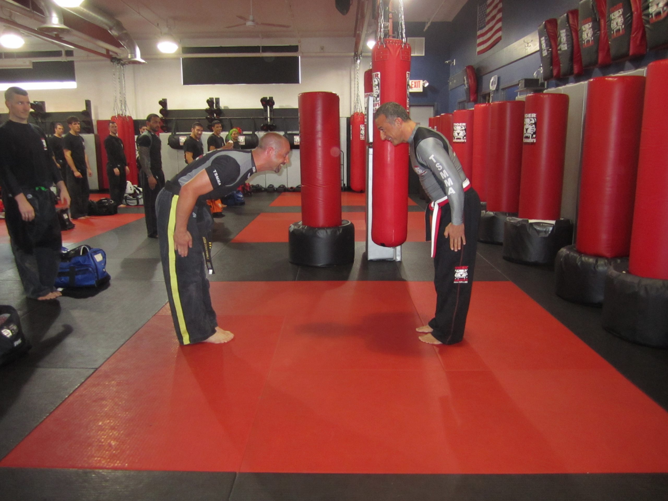 Men Bowing during the black belt ceremony at Tiger Schulmann's