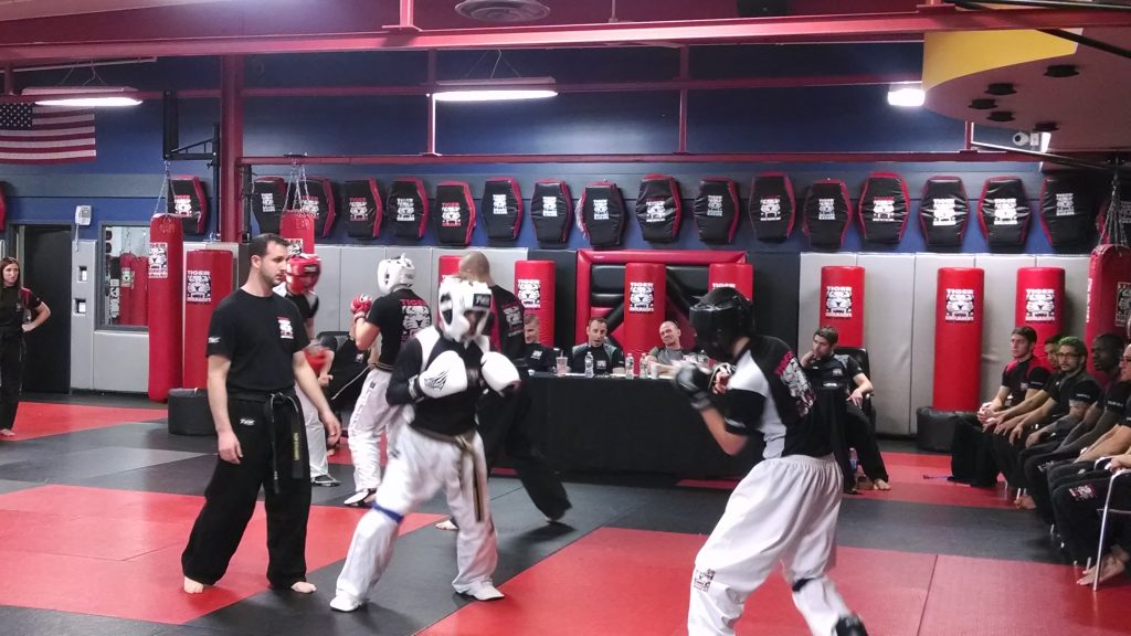 Two martial arts fighters sparring at Tiger Schulmann's gym