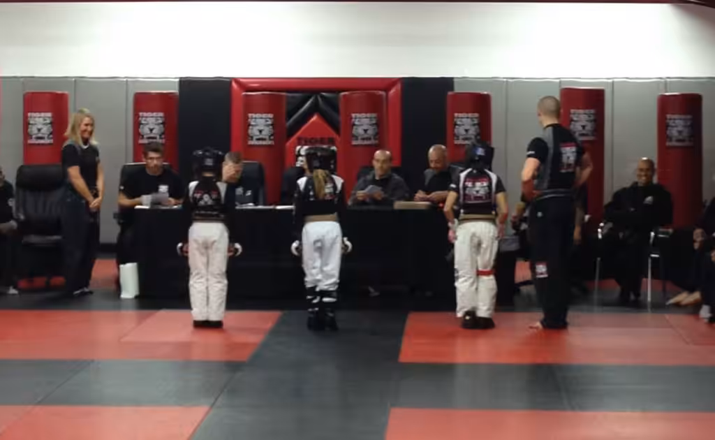 Three Tiger Schulmann's girl fighters in front of Judges