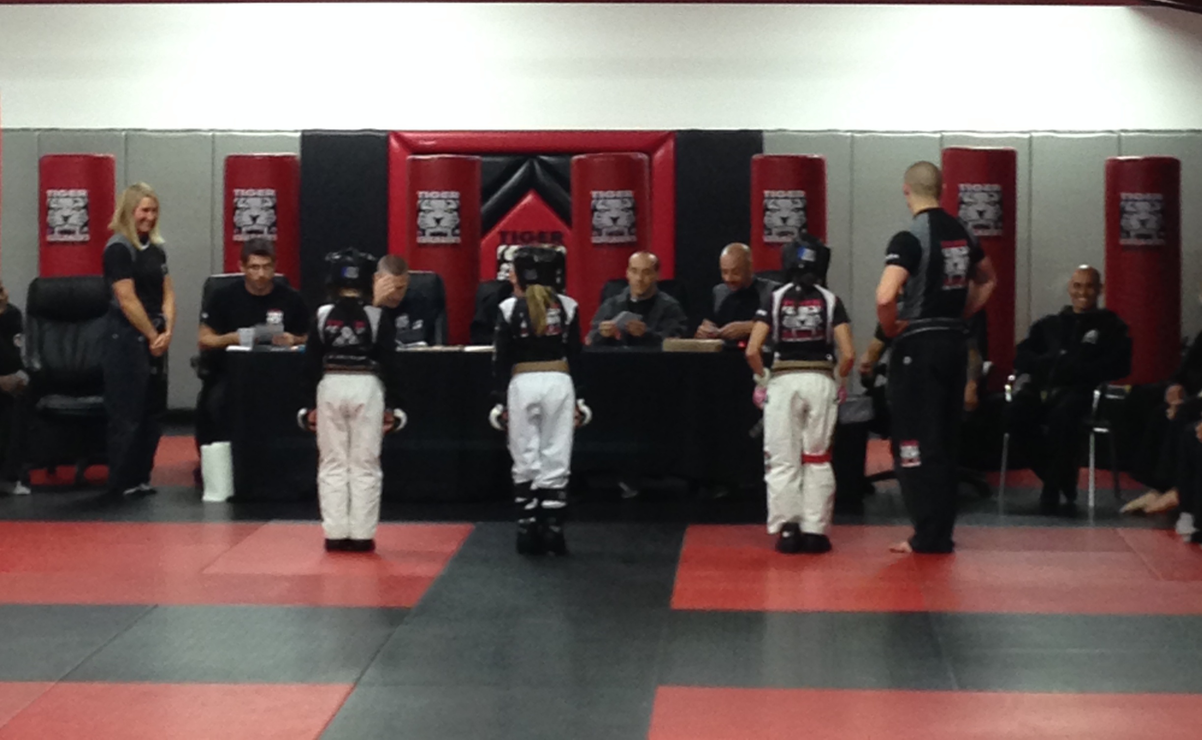 Three Tiger Schulmann's girl fighters in front of Judges