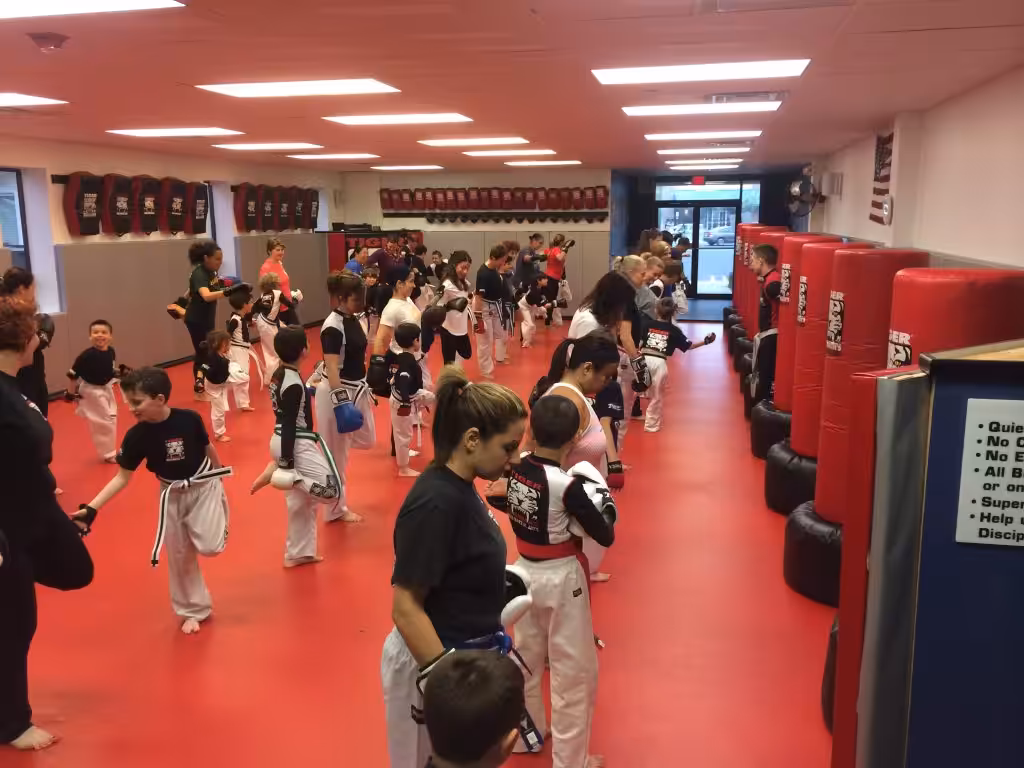 Children stretching with their mothers at Tiger Schulmann's training