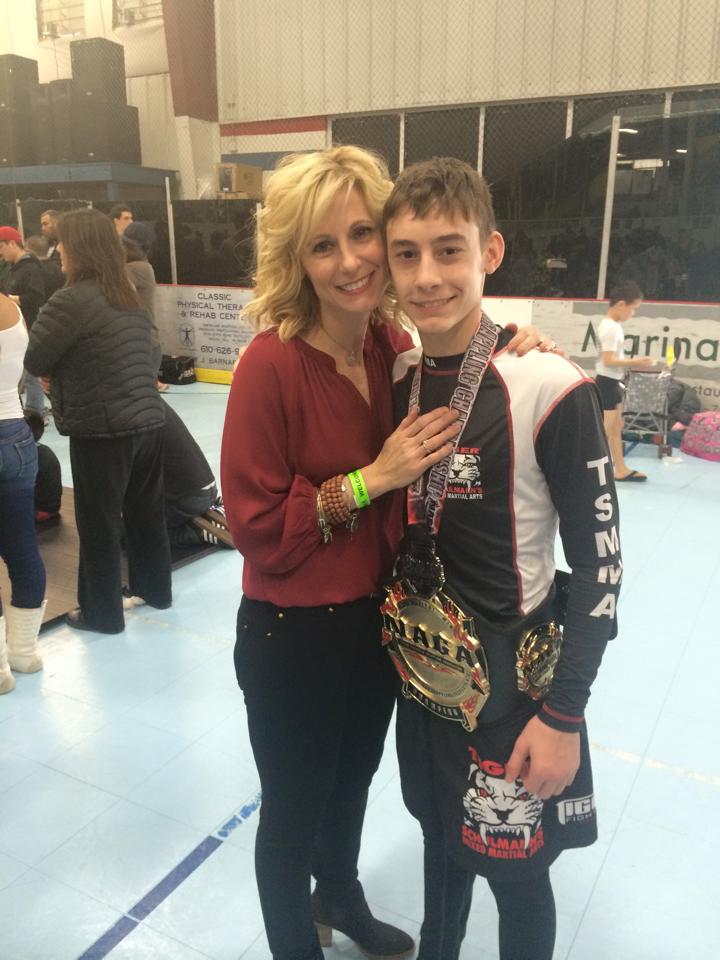Tiger Schulmann's fighter Boy with Medal next to his mom