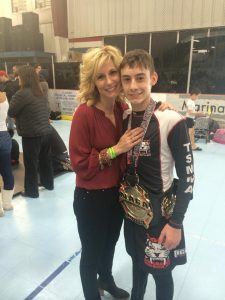 Ty poses with mom after winning first place at NAGA, a prestigious grappling tournament.