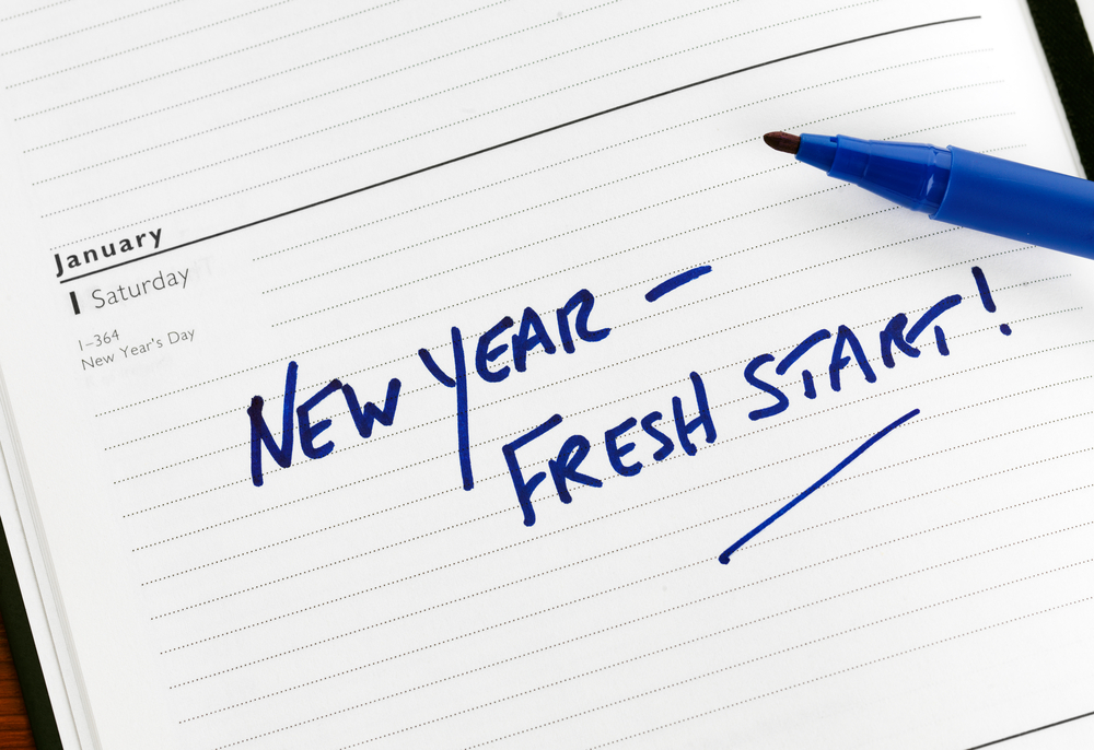 New Year - Fresh Start in blue letters in notebook