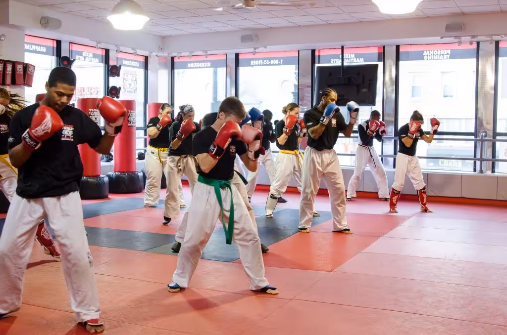 A group of fighters in punching pose on standing at Tiger Schulmann's East Brunswick