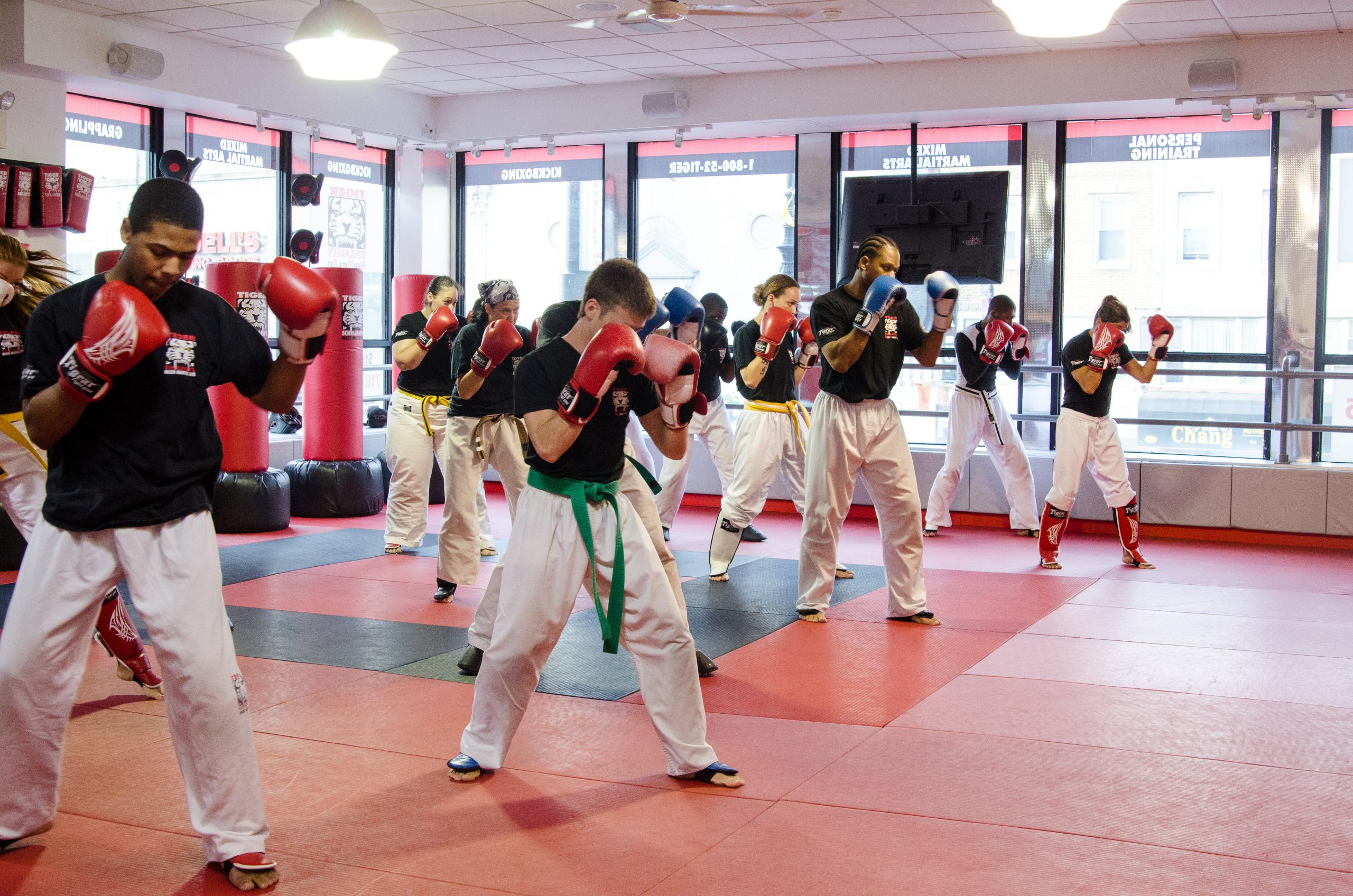 A group of fighters in punching pose on standing at Tiger Schulmann's East Brunswick