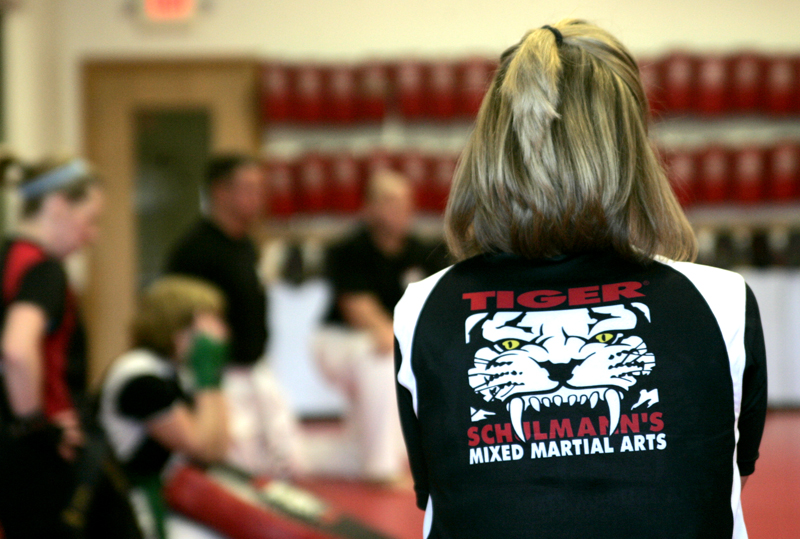 A girl's back with Tiger Schulmann's Martial Arts logo