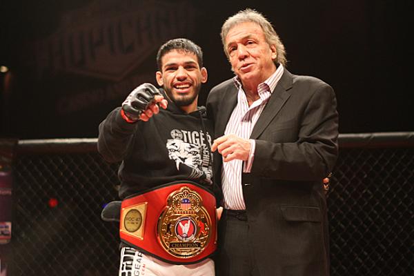 MMA fighter with championship belt and a man in suit