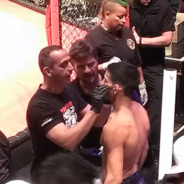 Medical team helping MMA fighter with Eye Injury during the fight