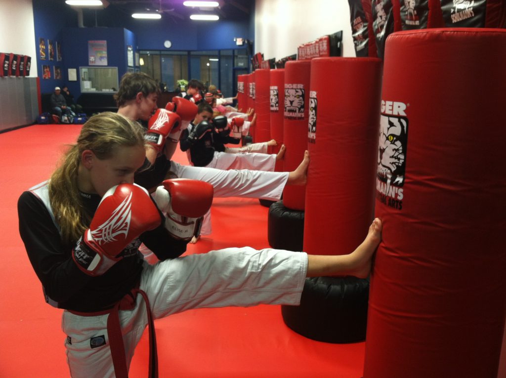 Children kickboxers practitcing kicking bags at Tiger Schulmann's