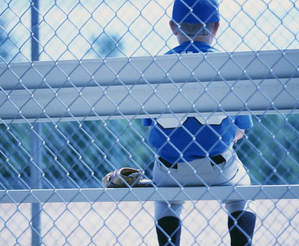 Boy Baseball Player Sitting on the Bench
