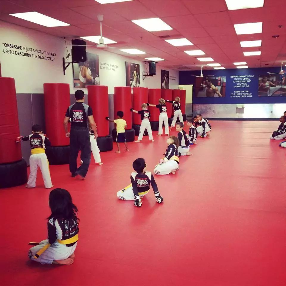 Children karate Training on Red Floor using punching bags at Tiger Schulmann's