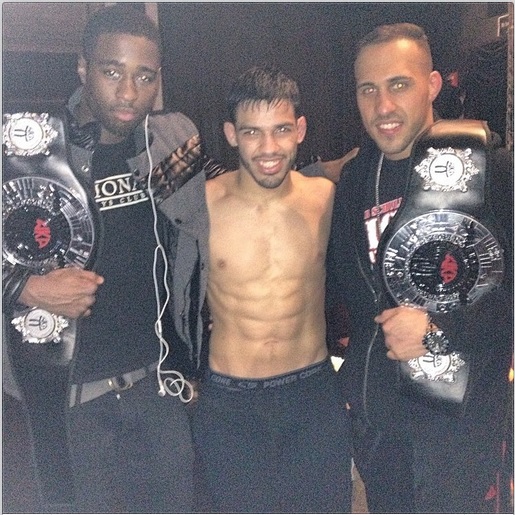 Three martial arts fighters Carrying Championship Belts at Tiger Schulmann's