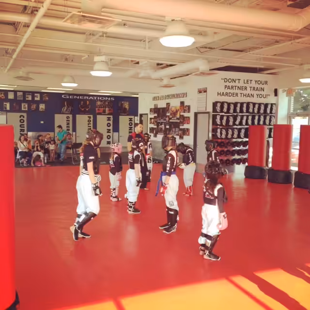 Kids standing and listening to instructor at Tiger Schulmann's Seaford