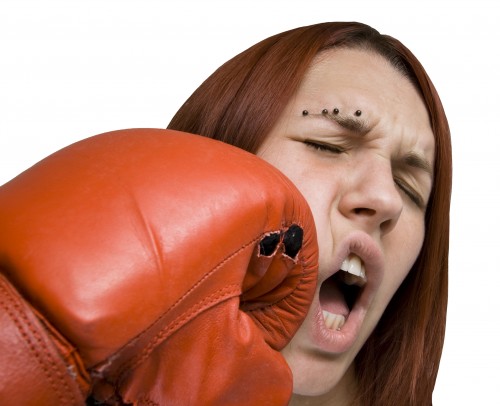 A woman gets punched in the face by the red glove