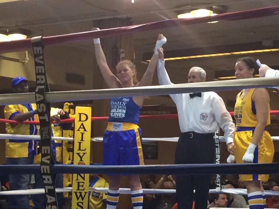 Referee raises hand of the winner Tiger Schulmann's girl fighter in ring