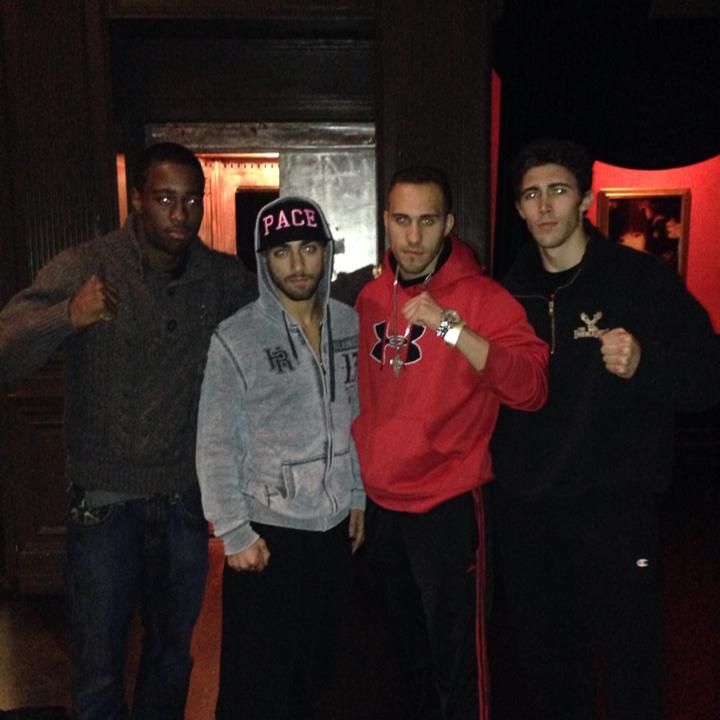 Four men MMA fighters outdoors at night in street clothes