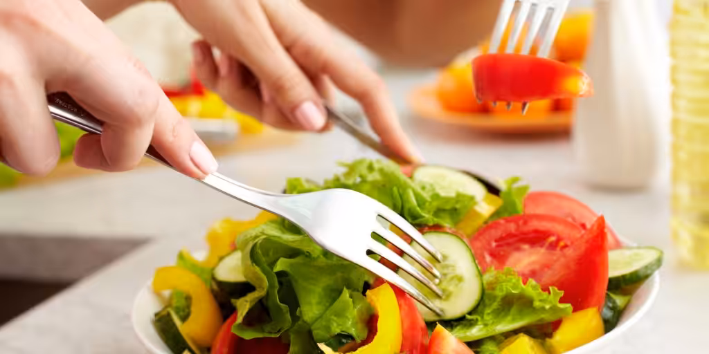 Green and red salad with forks