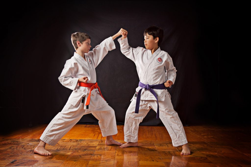 Two boys karate sparring at Tiger Schulmann's gym