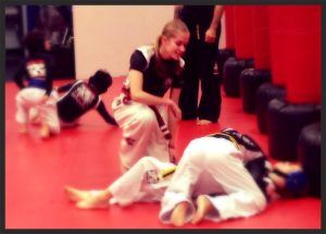 Kristina coaches younger students during the kids grappling class
