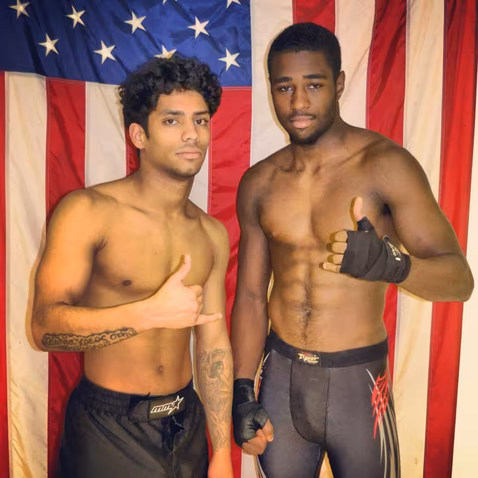 Two MMA fighters in front of american flag at Tiger Schulmann's