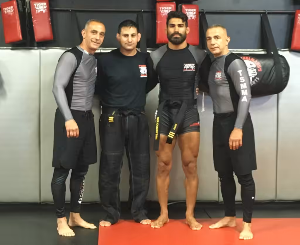 Four MMA fighters posing at Tiger Schulmann's gym