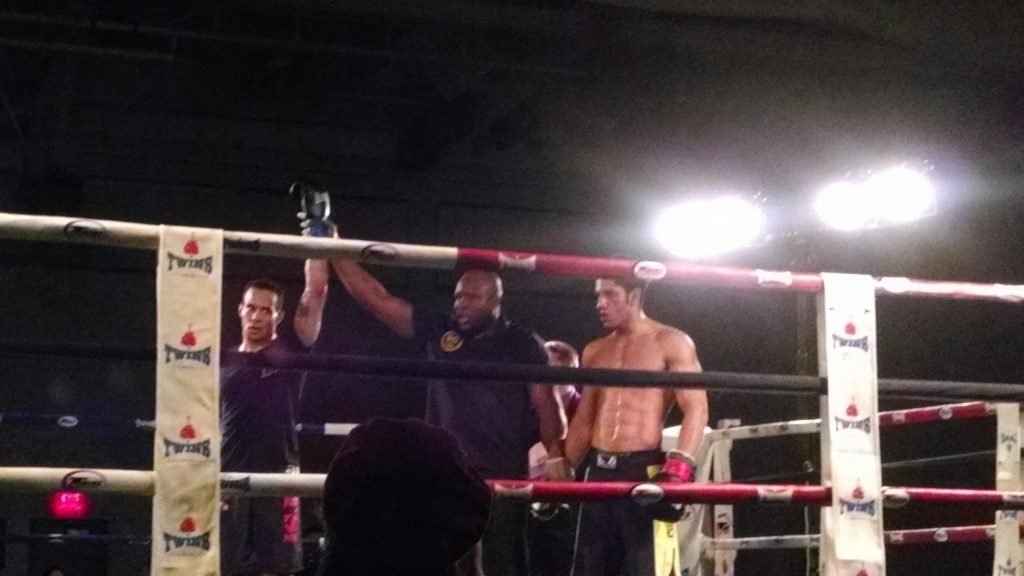 Referee raises hand of the winner Tiger Schulmann's fighter in ring