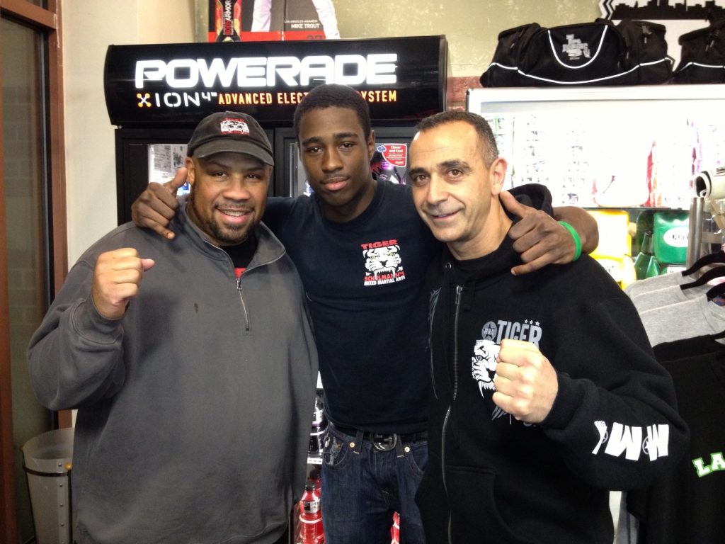 Three MMA fighters posing in Tiger Schulmann's Hoboken