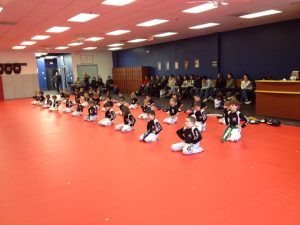 Kids Kneeling on the Floor with their parents sitting behind at Tiger Schulmann's