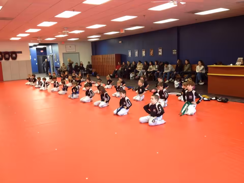 Kids Kneeling on the Floor with their parents sitting behind at Tiger Schulmann's