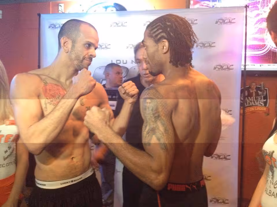 Two MMA fighters face off with fists up