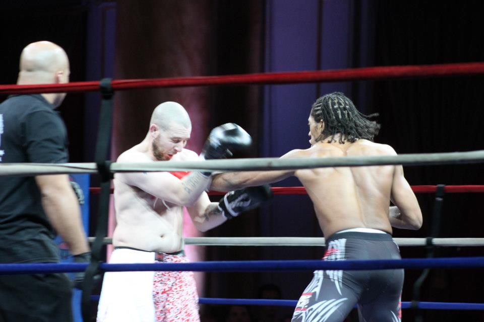 Two MMA fighters exchanging punches in the ring