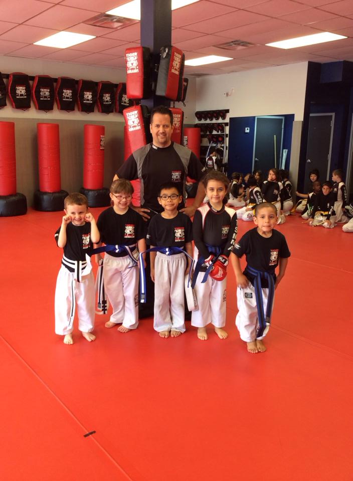 Five boy fighters and their instructor at red Tiger Schulmann's gym