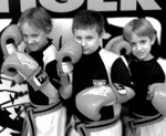 Three boys with boxing gloves at Tiger Schulmann's