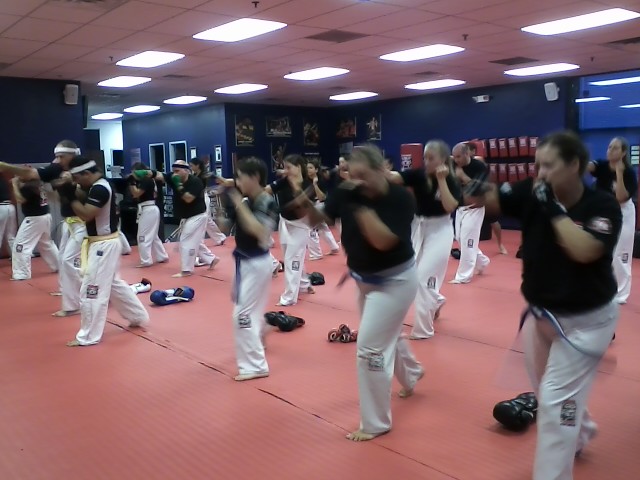 Adults and kids practicing punching at Tiger Schulmann's East Brunswick