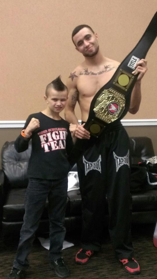 MMA with his championship belt and a boy