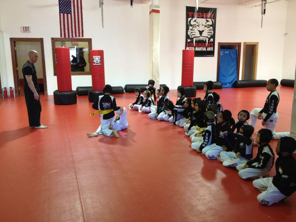 Kids Kneeling on the Floor and listening to instructor at Tiger Schulmann's